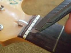 removing inlaid guitar nut